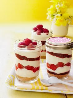 two desserts with raspberries are sitting on a plate