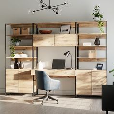 an office area with a desk, chair and shelving unit in the middle of it