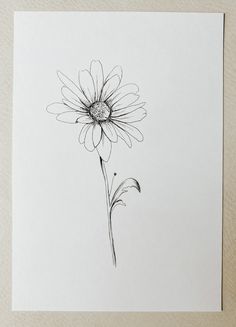 a black and white drawing of a flower on a piece of paper that has been drawn