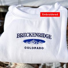 *SIZES ARE UNISEX* -I'd suggest your usual size for a more fitted look, or sizing up for a more relaxed fit. *these sweatshirts are extra comfy when oversized 🏔 "Breckenridge Colorado" with a mountain embroidered on a comfy vintage-style crewneck. Perfect for any occasion or gift for him or her. A sturdy and warm sweatshirt bound to keep you warm in the colder months. A pre-shrunk, classic fit sweater that's made with air-jet spun yarn for a soft feel and reduced pilling. Your new favorite swea Winter Sports Tops With Embroidered Logo, Winter Sporty Sweatshirt With Embroidered Text, Sporty Winter Sweatshirt With Embroidered Text, Sporty Sweatshirt With Embroidered Text For Winter, Sporty Crew Neck Sweatshirt For Hiking, Collegiate Winter Tops With Embroidered Text, Collegiate Style Winter Top With Embroidered Text, Sporty Winter Tops With Embroidered Text, Sporty Winter Top With Embroidered Text