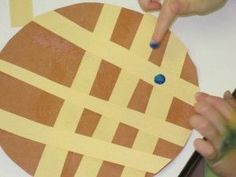 a child is making a paper plate craft