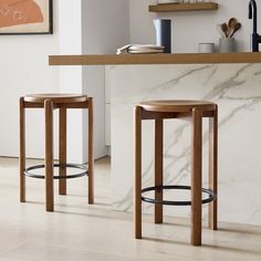 two stools sitting in front of a counter top