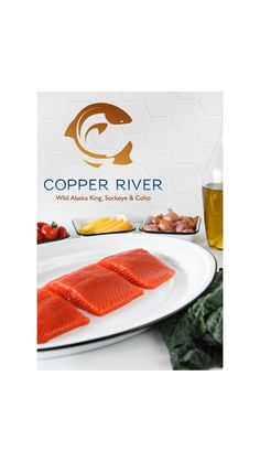 two salmons on a white plate next to some other foods and drinks in front of the copper river logo