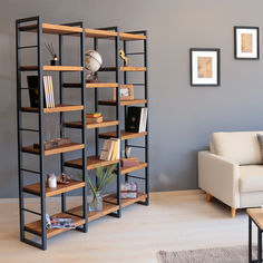 a living room filled with furniture and a book shelf