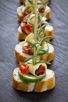 several slices of bread with vegetables and cheese on them are arranged in the shape of sandwiches