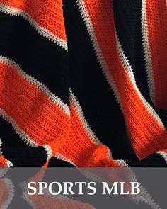 an orange and black crocheted blanket with the words sports'm b on it