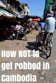 two people riding bicycles down the street with text overlaying how not to get robbed in cambodia