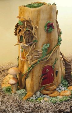 a cake made to look like a tree stump with a red door and mushrooms on it