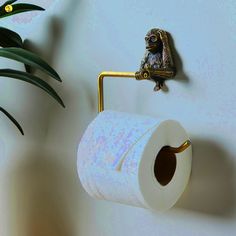 a toilet paper holder with a frog on it