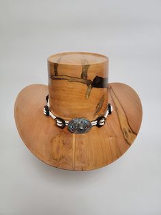 Beautiful wood-turned hat made from Ambrosia Maple signed and numbered by the artist, Brian Butler. Make a fashion statement in this unique hat! Measurements: Inside circumference: 22 inches Bill: 17.25" x 15" Height: 6.5" Weight: 3 lbs. ﻿Hatband and stand available for purchase separately. Western Handmade Top Hat With Flat Brim, Handmade Western Top Hat With Flat Brim, Unique Hat Bands For Rodeo And Kentucky Derby, Unique Adjustable Hat Bands For Country Events, Unique Flat Brim Hat For Western-themed Events, Unique Fedora With Curved Brim For Western-themed Events, Unique Fedora For Western-themed Events With Curved Brim, Unique Adjustable Hat Bands For Rodeo, Unique Adjustable Brown Hat Bands