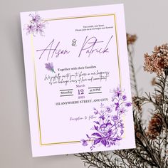 a wedding card with purple flowers on it