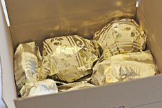 a box filled with lots of wrapped chocolates