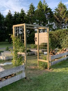 an outdoor garden area with various types of plants and animals in the fenced off area