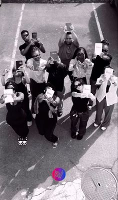 a group of people standing next to each other holding up signs in front of them