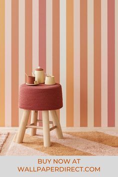 a pink and orange striped wallpaper with wooden stools