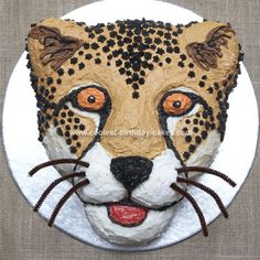 a cake made to look like a leopard's face on top of a plate