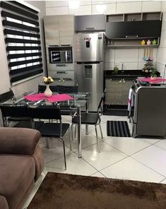 a modern kitchen with stainless steel appliances and furniture