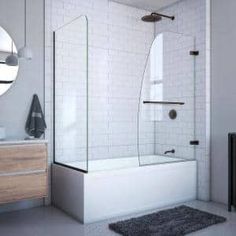 a bathroom with a sink, mirror and bathtub next to a towel on the floor