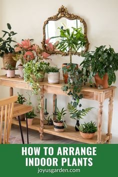 a wooden table topped with potted plants next to a mirror