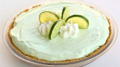 a pie with cucumber slices and whipped cream on top