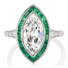 Marquise Diamond & Emerald Halo Engagement Ring The Gretchen 2.19 ring is a VB original design made right here in NYC. The ring centers a GIA-certified 2.19-carat Marquise cut diamond of G color, SI1 clarity. The stone is set in a platinum setting. Twenty carré cut emeralds are channel-set into a platinum halo surrounding the center stone with 3 old European cut diamonds set into each tapering shoulder. The ring is currently size 5.75 and can be resized! Why We Love It A stunning creation, i Emerald Halo Engagement Ring, Art Deco Jewelry Rings, Victor Barbone Jewelry, Victor Barbone, Halo Engagement Ring Emerald, Emerald Halo, Marquise Diamond Engagement Ring, Vintage Art Deco Rings, Marquise Diamond Ring