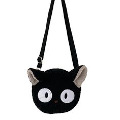 a black cat purse with white eyes and ears on the front, hanging from a strap