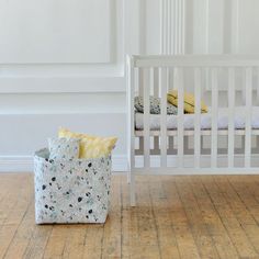 two baby cribs sitting next to each other in a room with white walls