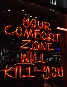 a neon sign that says your comfort zone will kill you