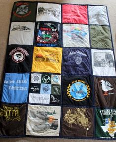 there is a quilt made to look like it has many different patches and logos on it