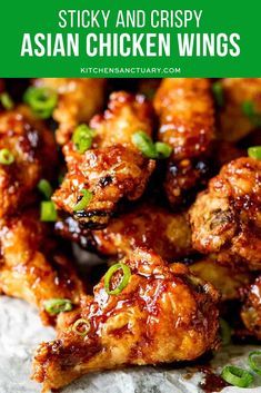 chicken wings covered in sauce and green onions