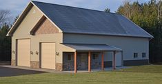 an image of a two story garage in the middle of a field