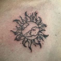 a sun and cloud tattoo on the chest