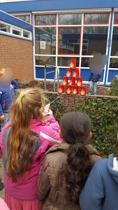 some kids are looking at something in front of a building