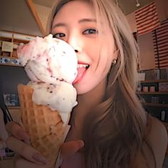 a woman is eating an ice cream cone