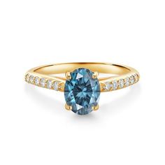 a blue diamond ring with diamonds on the band and side stones in 18k yellow gold