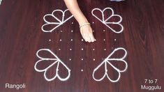 a person standing on a wooden floor with white string art