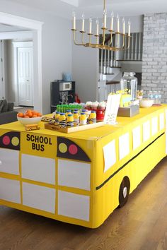 a school bus shaped food cart in the middle of a living room with wood floors