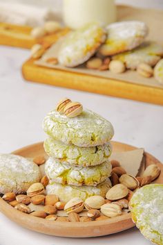 some cookies and almonds are stacked on a plate