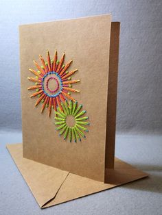 a card with colored crayons in the shape of a sunburst on it