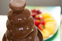 a chocolate fondant stacked on top of each other in front of a plate of fruit