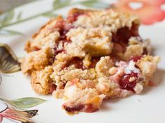 a close up of a plate of food with crumbs and fruit on it