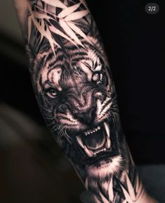 a black and white tiger tattoo on the arm