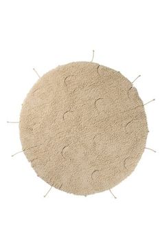 a round rug with holes in the middle on a white background, it is made out of