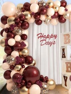 an arch made out of balloons with the words happy birthday written in red and gold