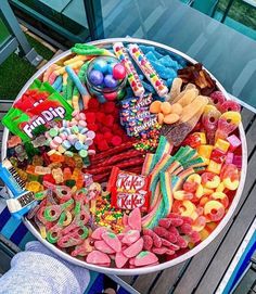 a bowl filled with lots of candy on top of a table