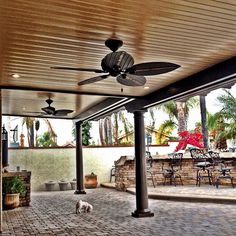 a patio with a ceiling fan and outdoor dining area