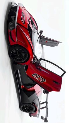 a red sports car hanging from the side of a wall