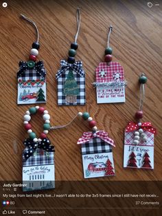 christmas tags are hanging on a table with some decorations around them and the tag is made from wood beads