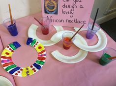 the table is set up with paper plates and crafting supplies for children to make