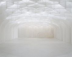 an empty room with white walls and ceiling